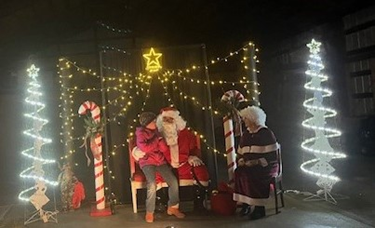 Mr. and Mrs. Claus hand out candy.